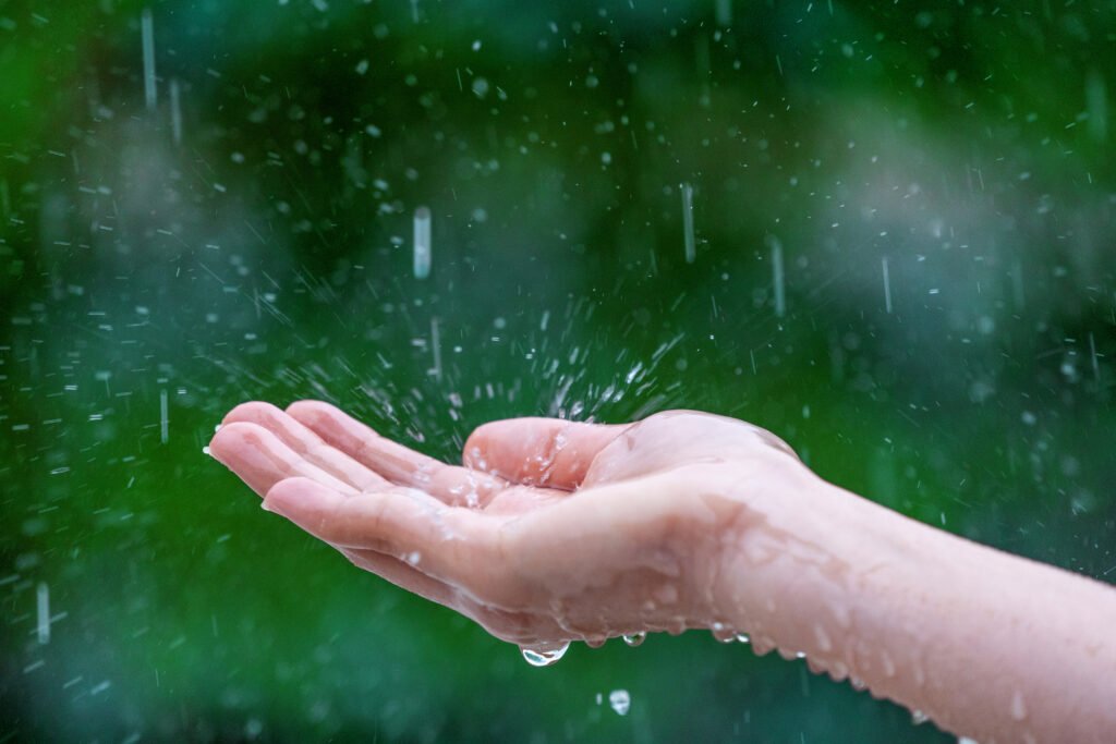 A hand holding a water droplet, showcasing Andaman monsoon magic. Budget Friendly Trip to Andaman