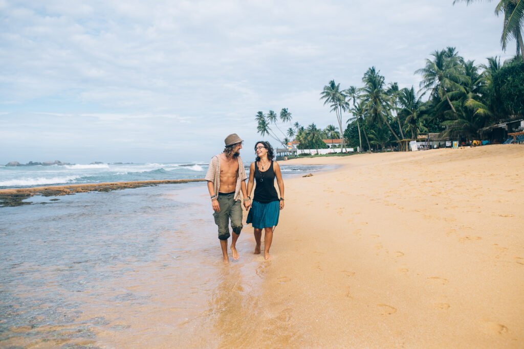 A couple strolling on a sandy beach in Andaman Island, enjoying a budget-friendly trip to Andaman