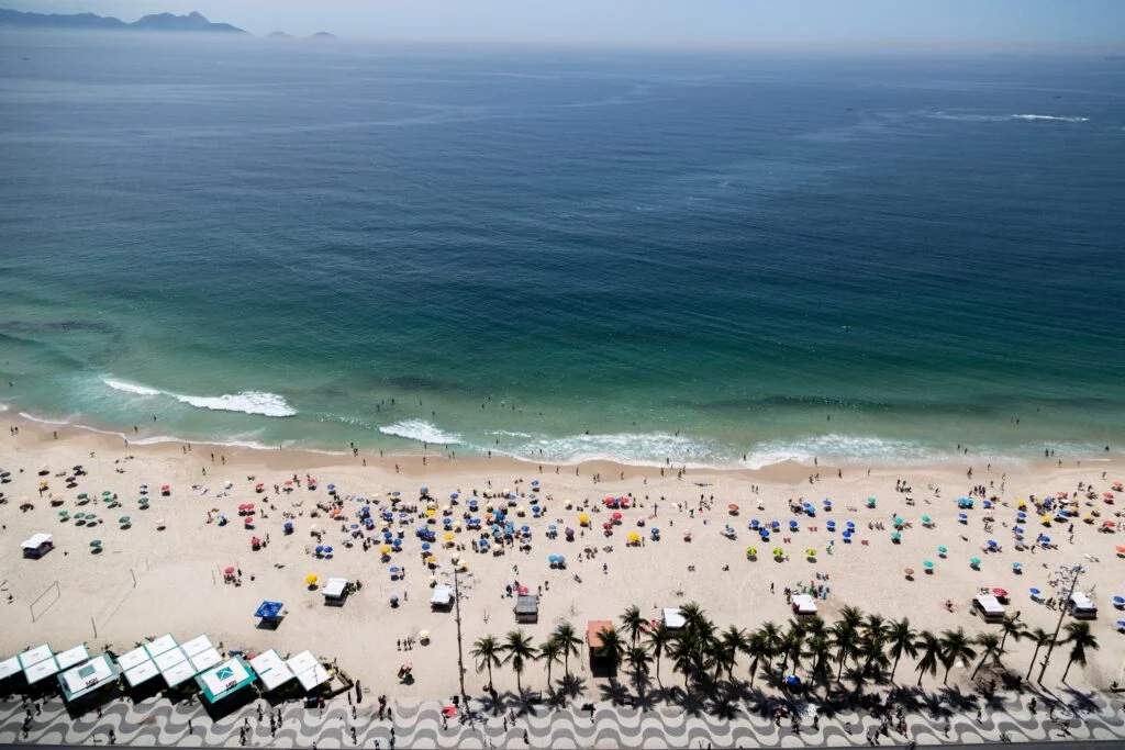 This image has an empty alt attribute; its file name is aerial-shot-copacabana-beach-rio-de-janeiro-brazil-crowded-with-people-1024x683.jpg